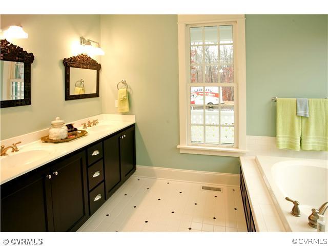 15931 Alsdell Road Midlothian, VA 23112 - Photo 8 of 12 a bathroom with a tub sink and a mirror