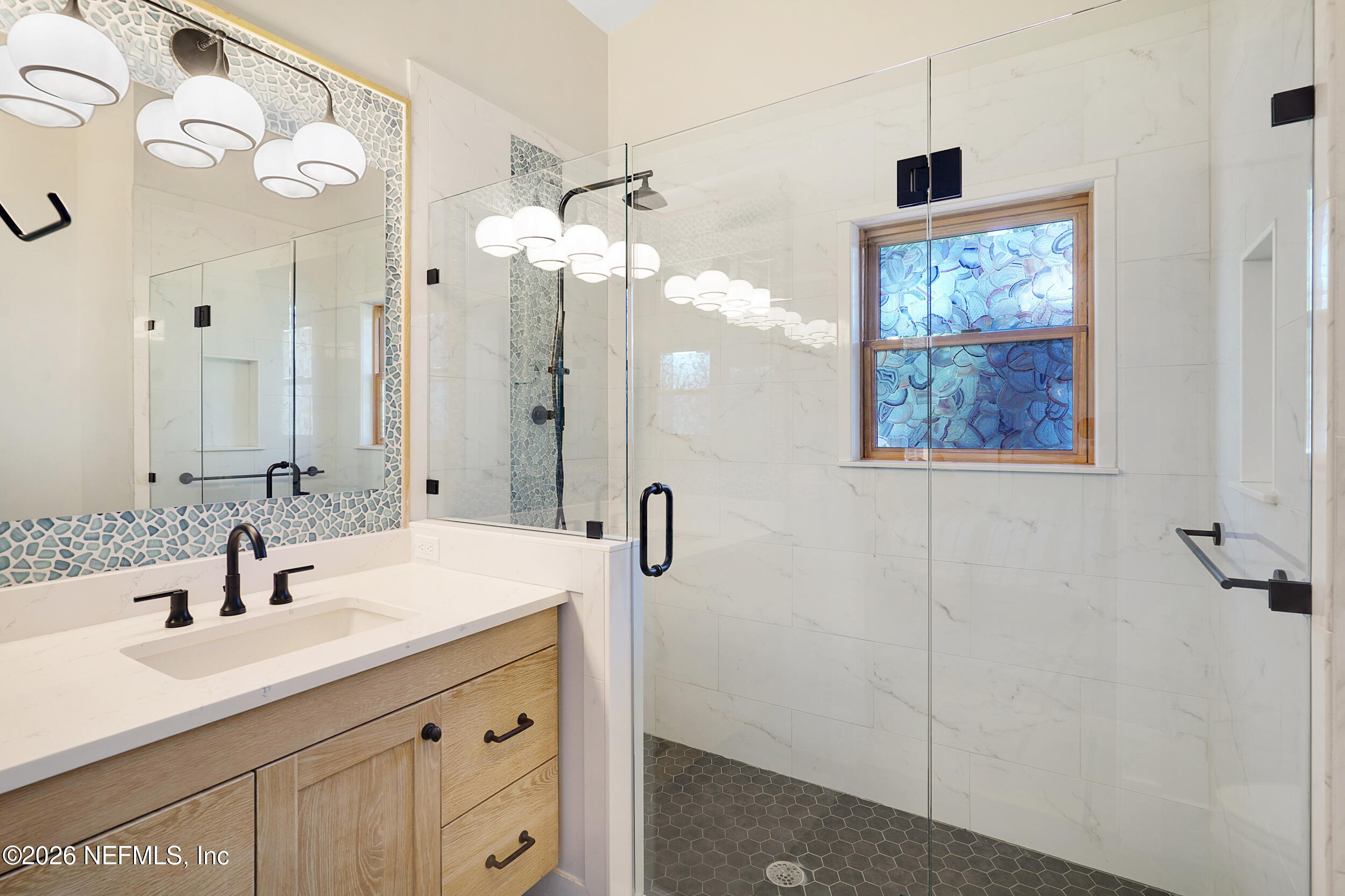 290 St George Street, Unit B St. Augustine, FL 32084 - Photo 12 of 19 a bathroom with a sink and a mirror