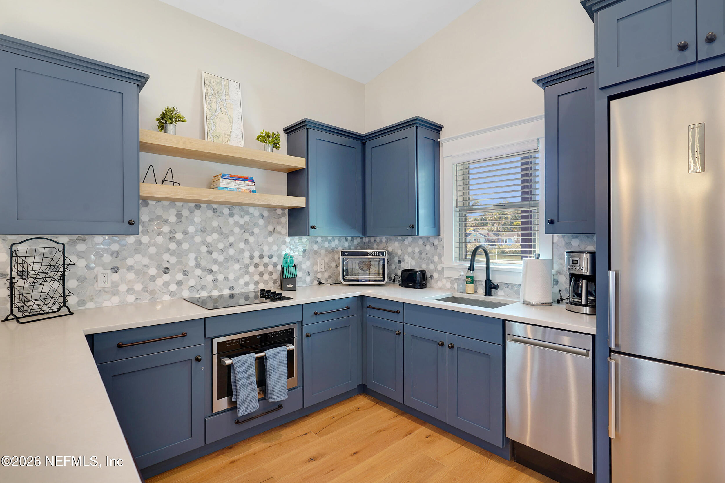 290 St George Street, Unit B St. Augustine, FL 32084 - Photo 9 of 19 a kitchen with stainless steel appliances granite countertop a sink stove and refrigerator