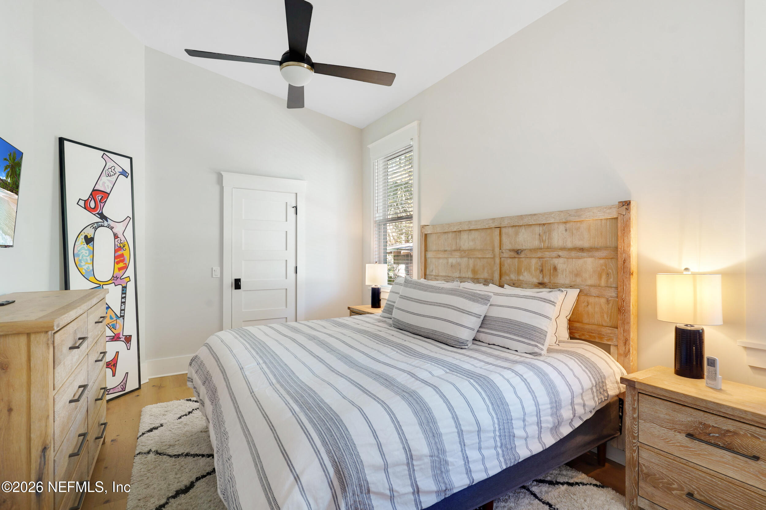 290 St George Street, Unit B St. Augustine, FL 32084 - Photo 10 of 19 a bedroom with a bed and a painting on the wall