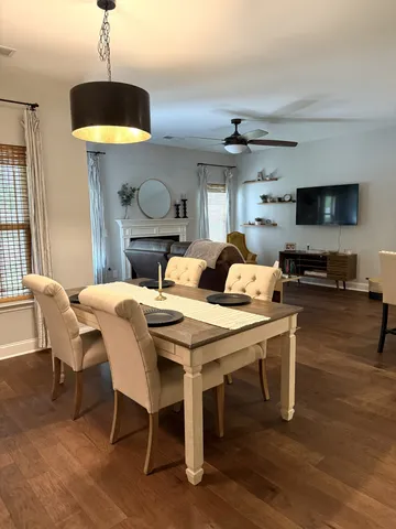 a dining room with a table chairs and a kitchen view