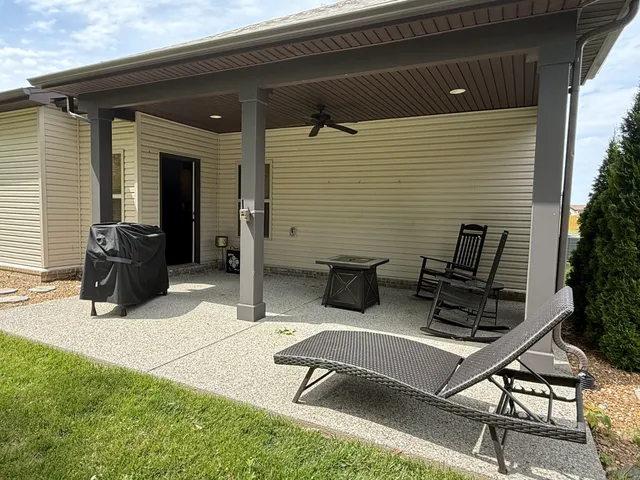 a view of a patio with a table and chairs and potted plants