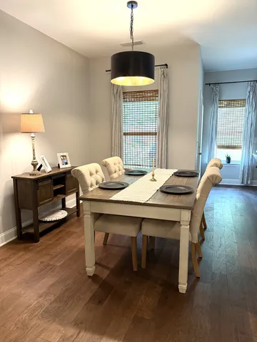 a view of a dining room with furniture and window