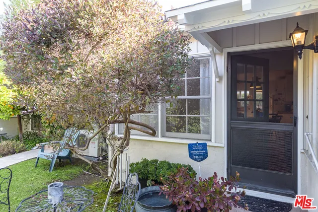 a house with lots of trees in front of it
