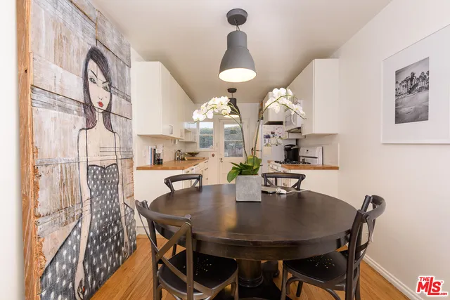 a view of a dining room with furniture and chandelier