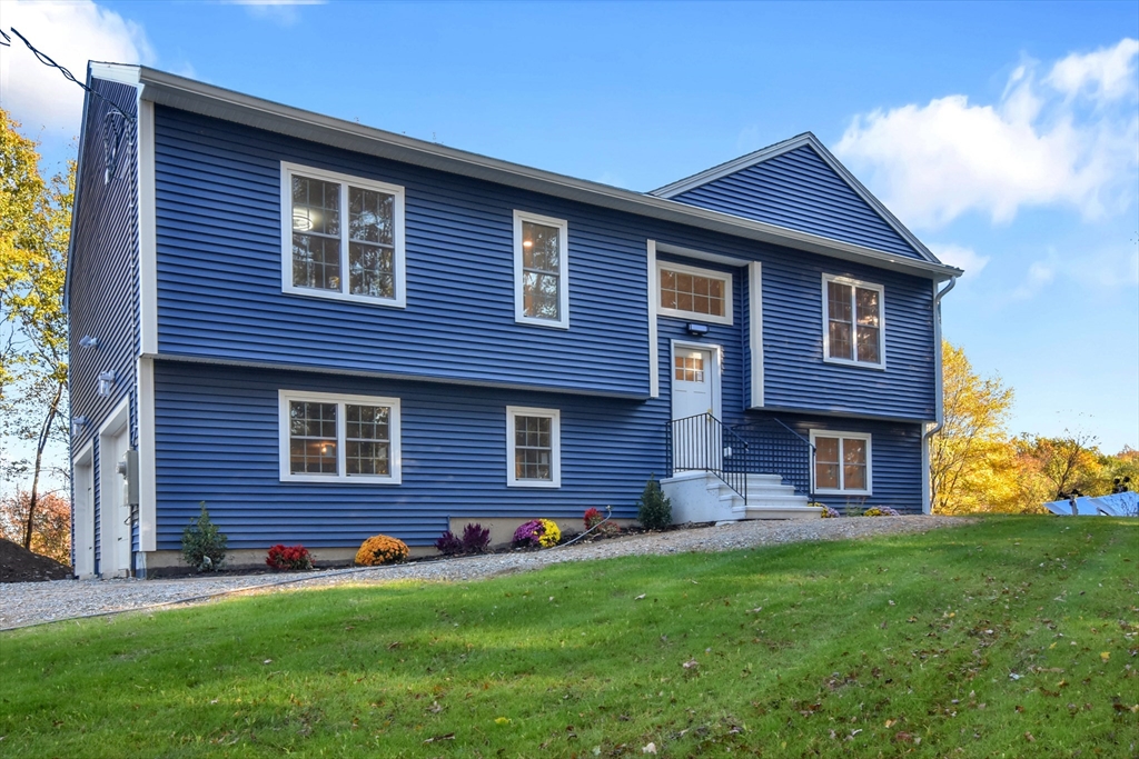 a brick house with a small yard and front a yard
