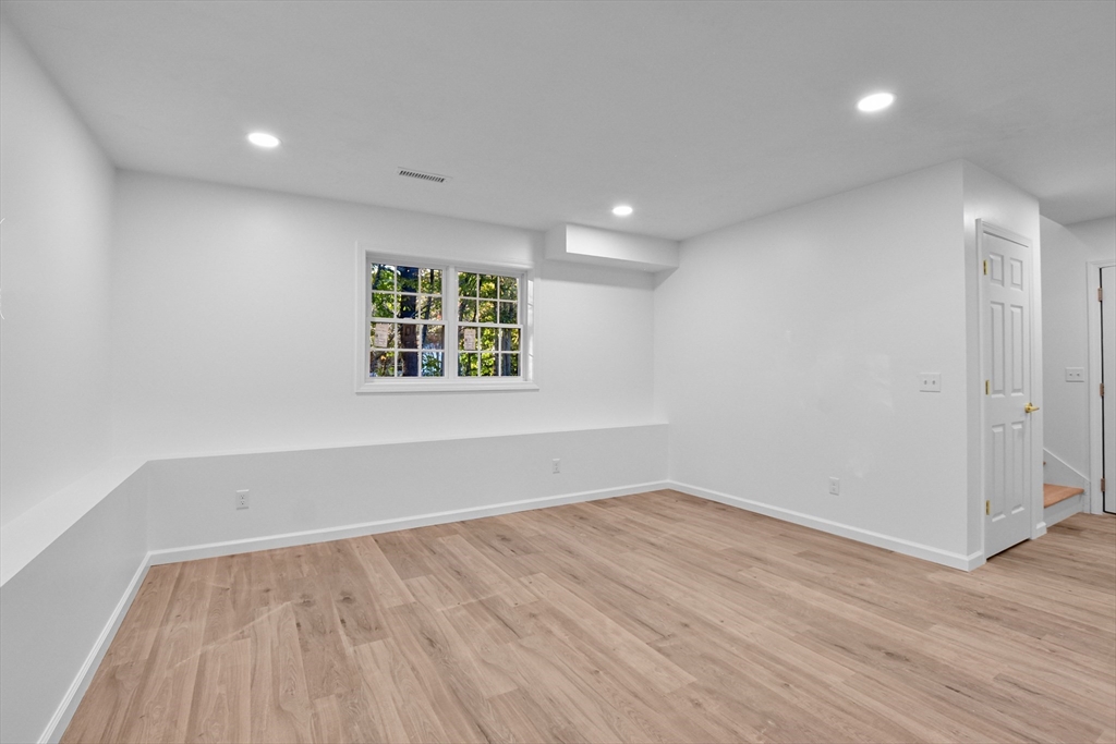 76 Number 6 Schoolhouse Road Charlton, MA 01507 - Photo 18 of 29 an empty room with wooden floor and windows