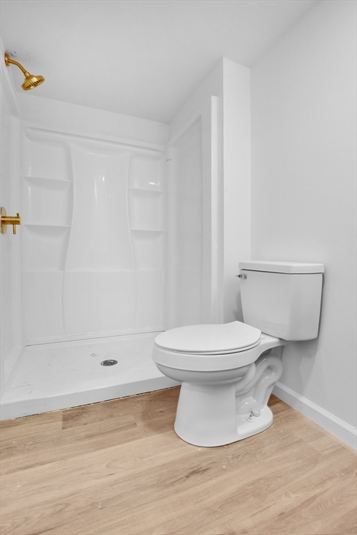 76 Number 6 Schoolhouse Road Charlton, MA 01507 - Photo 21 of 29 a white toilet sitting next to a bath tub and a shower