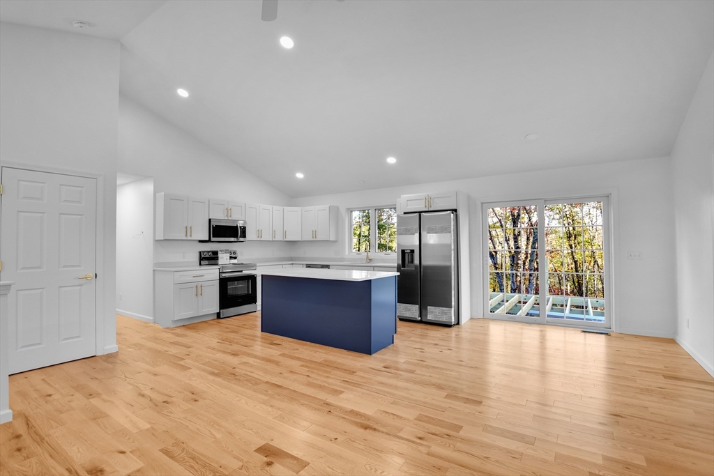 76 Number 6 Schoolhouse Road Charlton, MA 01507 - Photo 3 of 29 a large kitchen with stainless steel appliances kitchen island granite countertop a large counter top and oven
