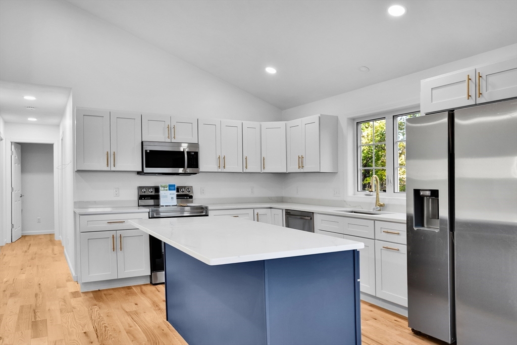 76 Number 6 Schoolhouse Road Charlton, MA 01507 - Photo 5 of 29 a kitchen with stainless steel appliances a sink a stove a refrigerator cabinets and a counter top space