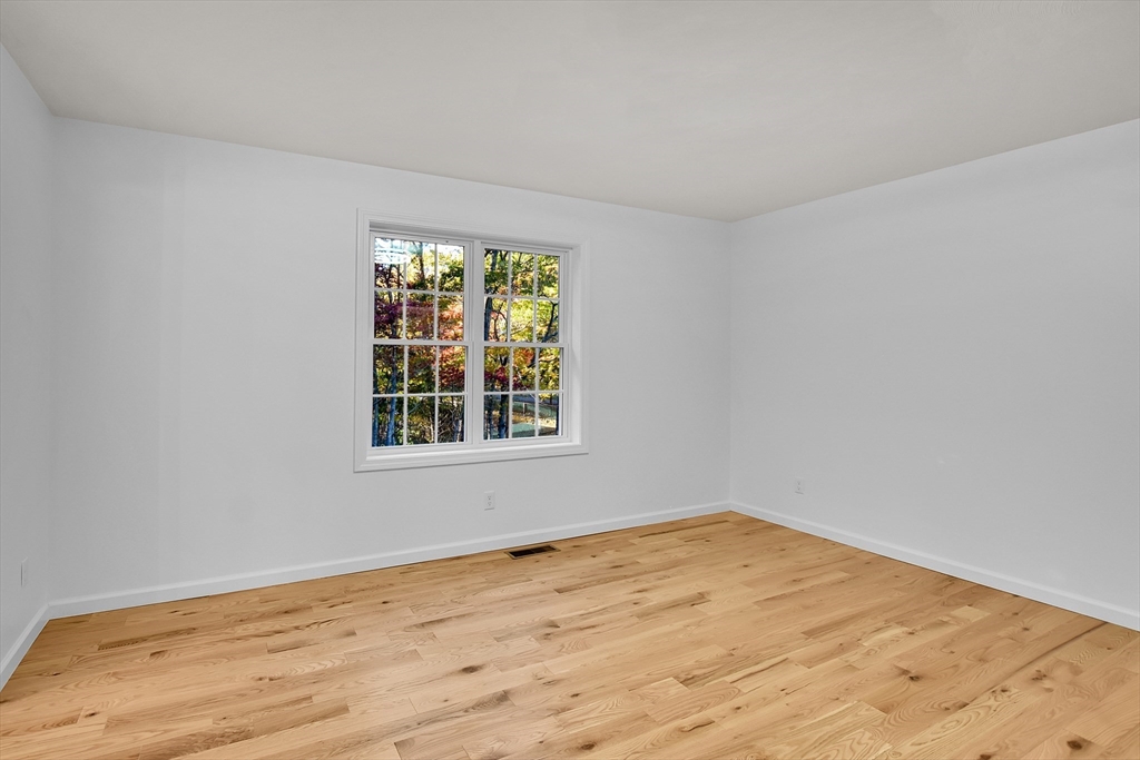 76 Number 6 Schoolhouse Road Charlton, MA 01507 - Photo 9 of 29 a view of empty room with wooden floor and fan