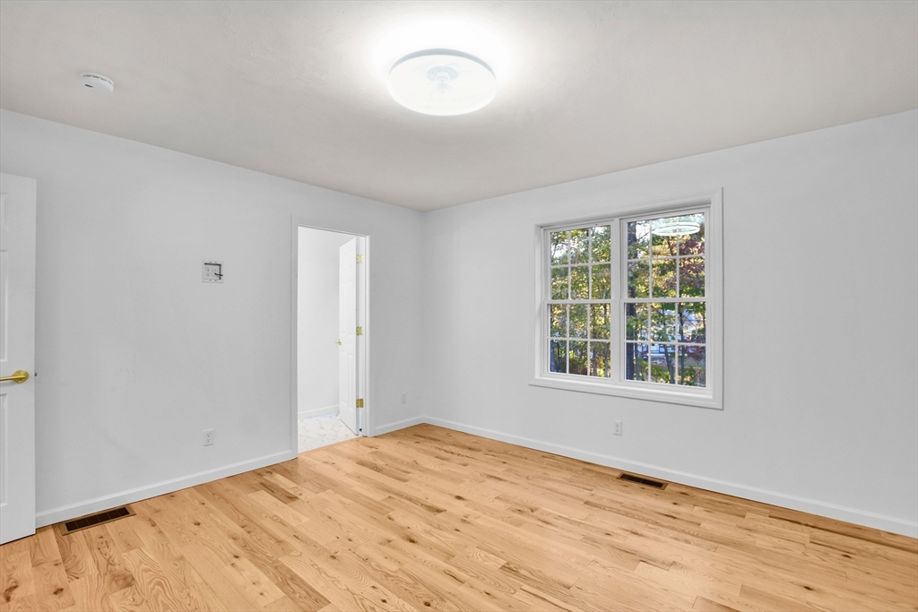 76 Number 6 Schoolhouse Road Charlton, MA 01507 - Photo 10 of 29 a view of an empty room with a window