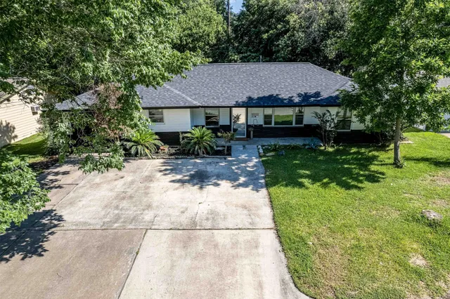 a view of house with yard and entertaining space