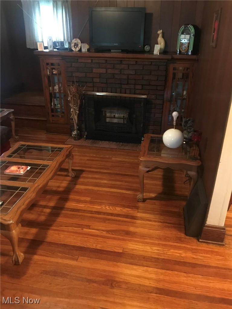 720 Kipling Street Akron, OH 44306 - Photo 10 of 21 Living room with a fireplace and wood finished floors