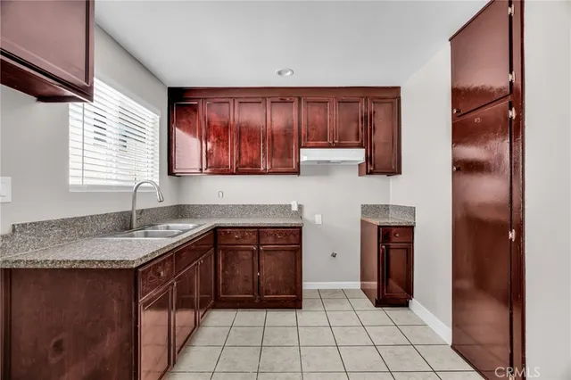 a kitchen with stainless steel appliances granite countertop wooden cabinets a sink and dishwasher