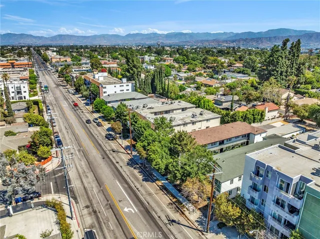 a picture of a city with lots of residential buildings ocean and mountain view in back