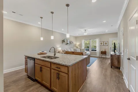 a kitchen with stainless steel appliances granite countertop a refrigerator stove and sink