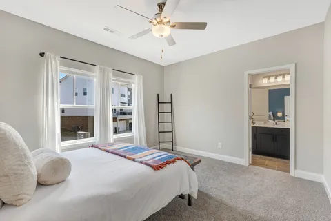 a bathroom with a sink a toilet a mirror and shower