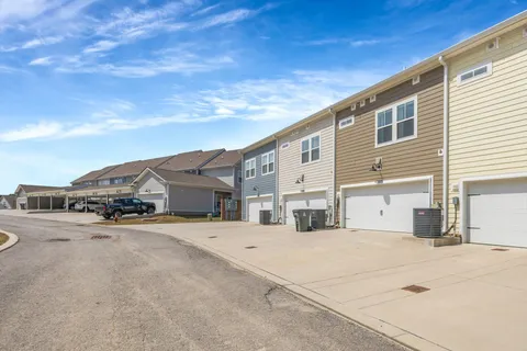 a front view of residential houses with yard and swimming pool