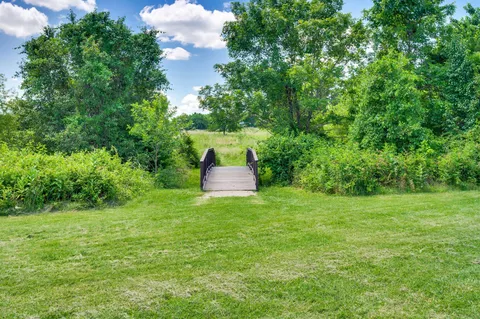 a sign broad in front of red brick house