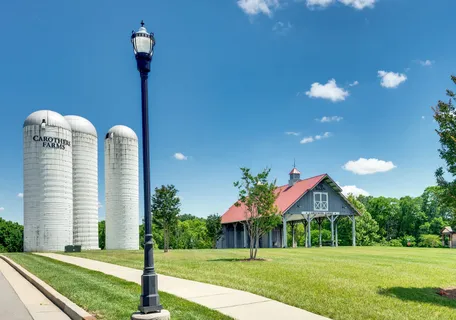 a view of a house with a small yard and potted plants