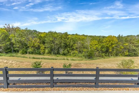 a living room with furniture and a ceiling fan