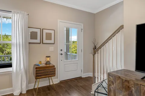 a living room with furniture kitchen view and a chandelier