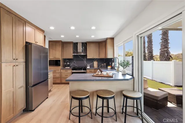 a kitchen with refrigerator and cabinets