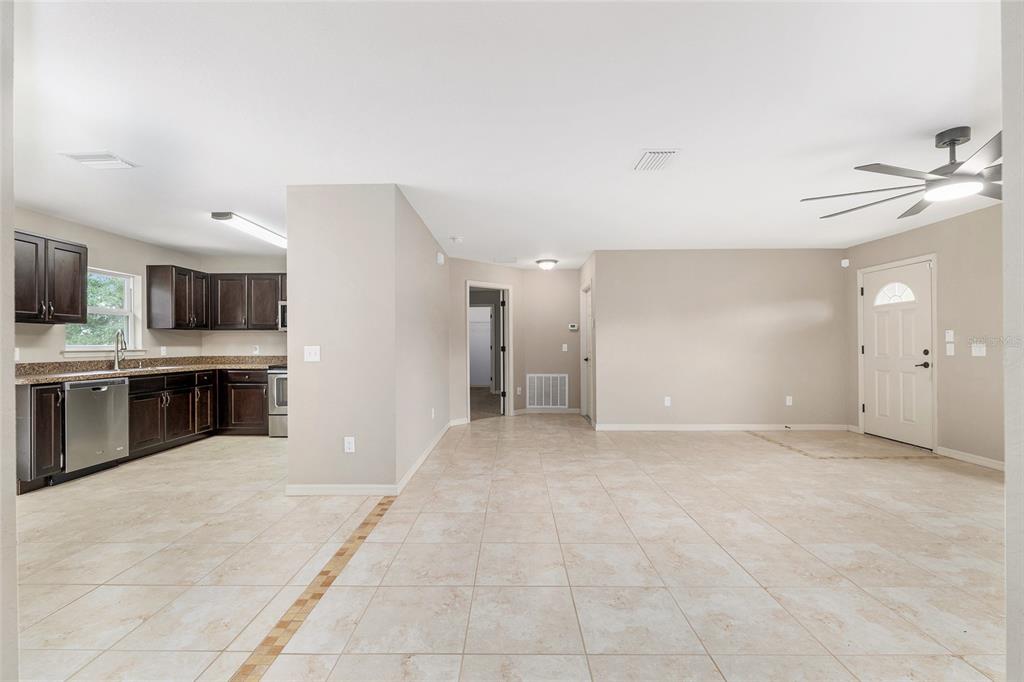 2 Hemlock Loop Drive Ocala, FL 34472 - Photo 7 of 28 a view of an empty room with kitchen and window