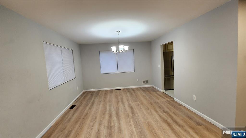 121 Broadway Cresskill, NJ 07626 - Photo 10 of 17 an empty room with wooden floor and windows