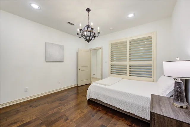 a kitchen with kitchen island granite countertop a refrigerator and a sink
