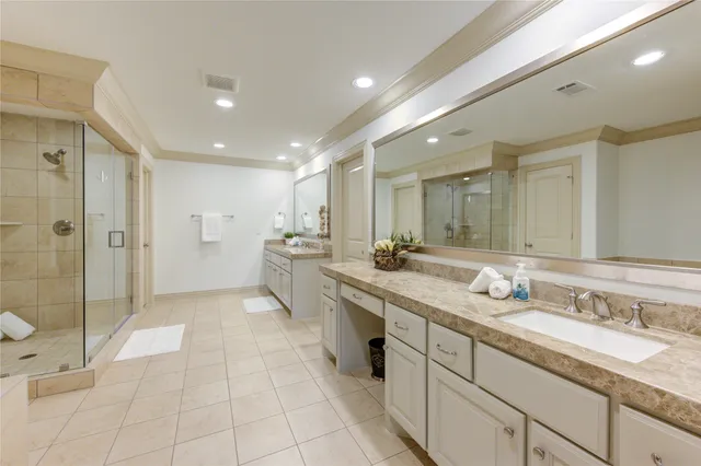 a spacious bathroom with a granite countertop sink mirror and shower