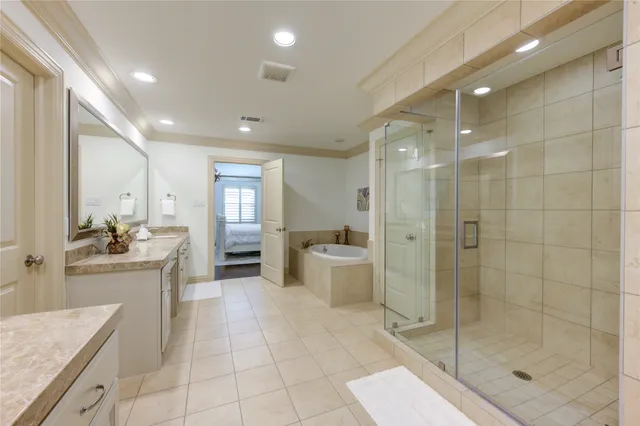 a large bathroom with a granite countertop sink a toilet a mirror and shower