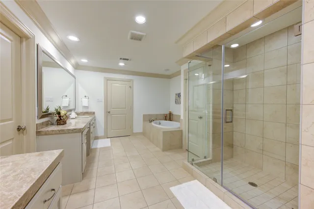 a large bathroom with a granite countertop sink a toilet a mirror and shower