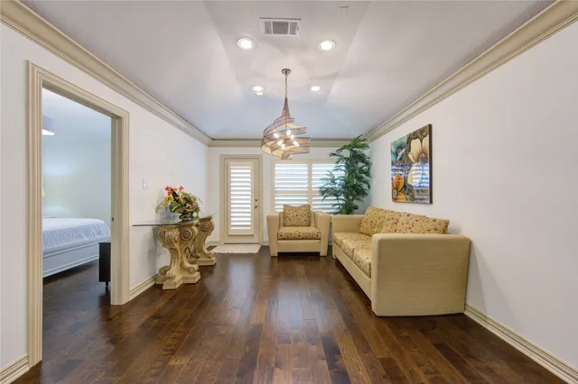 a living room with furniture and a chandelier