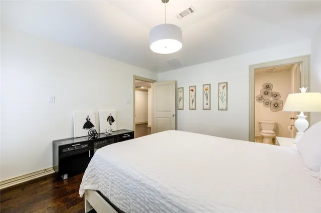 a bathroom with a granite countertop sink a toilet and shower