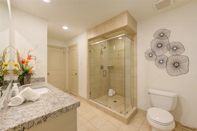 a bathroom with a granite countertop sink a mirror and a shower