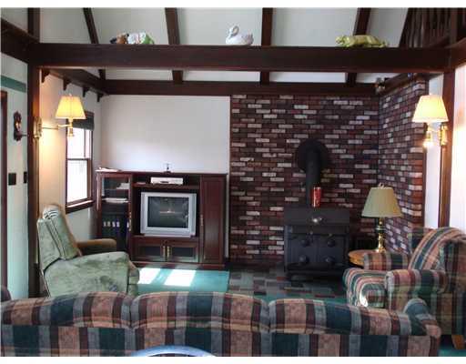 255 Limerick Road Herminie, PA 15637 - Photo 2 of 6 Living Room. Cathedral Ceiling, sliding doors to deck, open floor plan to kitchen and dining, wood burner, warm and comfortable!