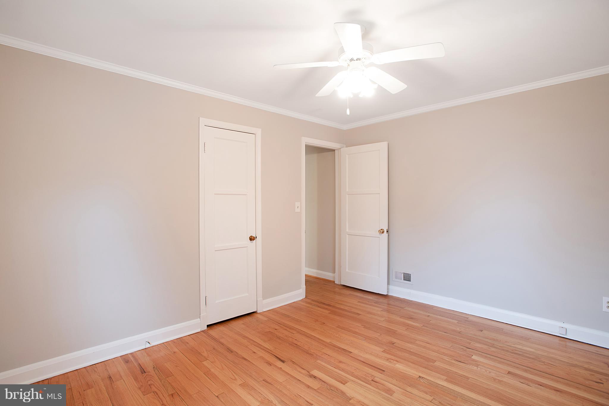 3300 Garnet Road Baltimore, MD 21234 - Photo 18 of 55 an empty room with wooden floor and fan