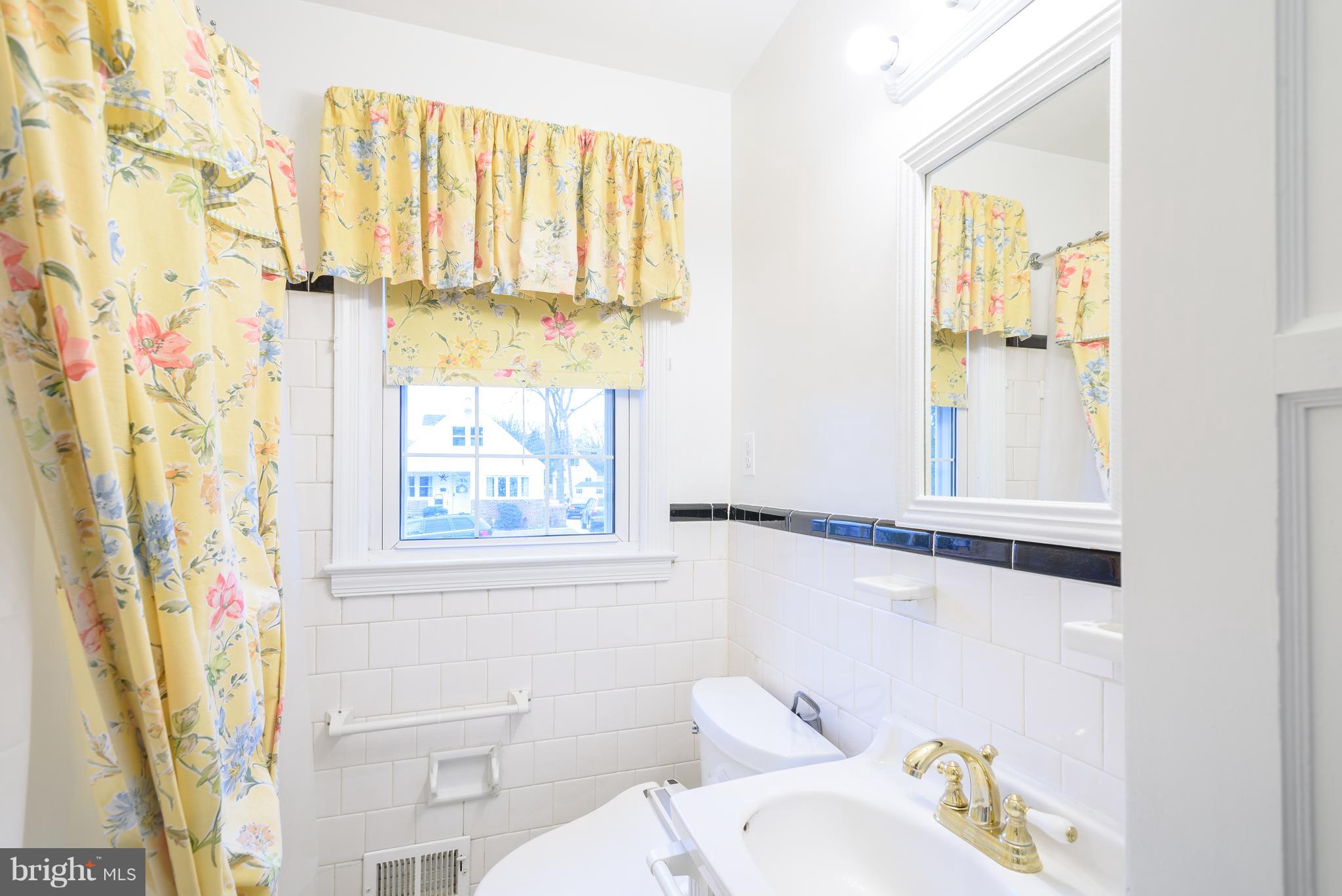 3300 Garnet Road Baltimore, MD 21234 - Photo 22 of 55 a bathroom with a window a sink and a toilet