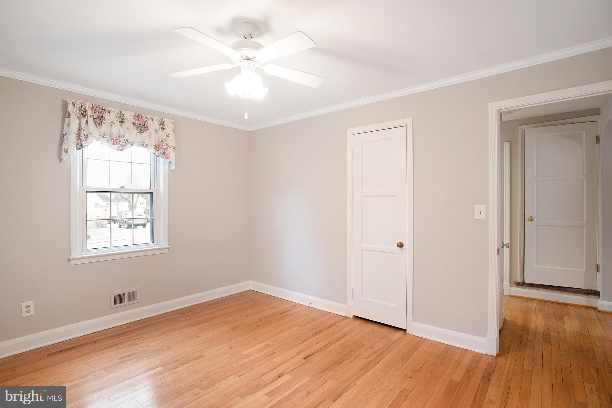 3300 Garnet Road Baltimore, MD 21234 - Photo 45 of 55 an empty room with wooden floor and windows