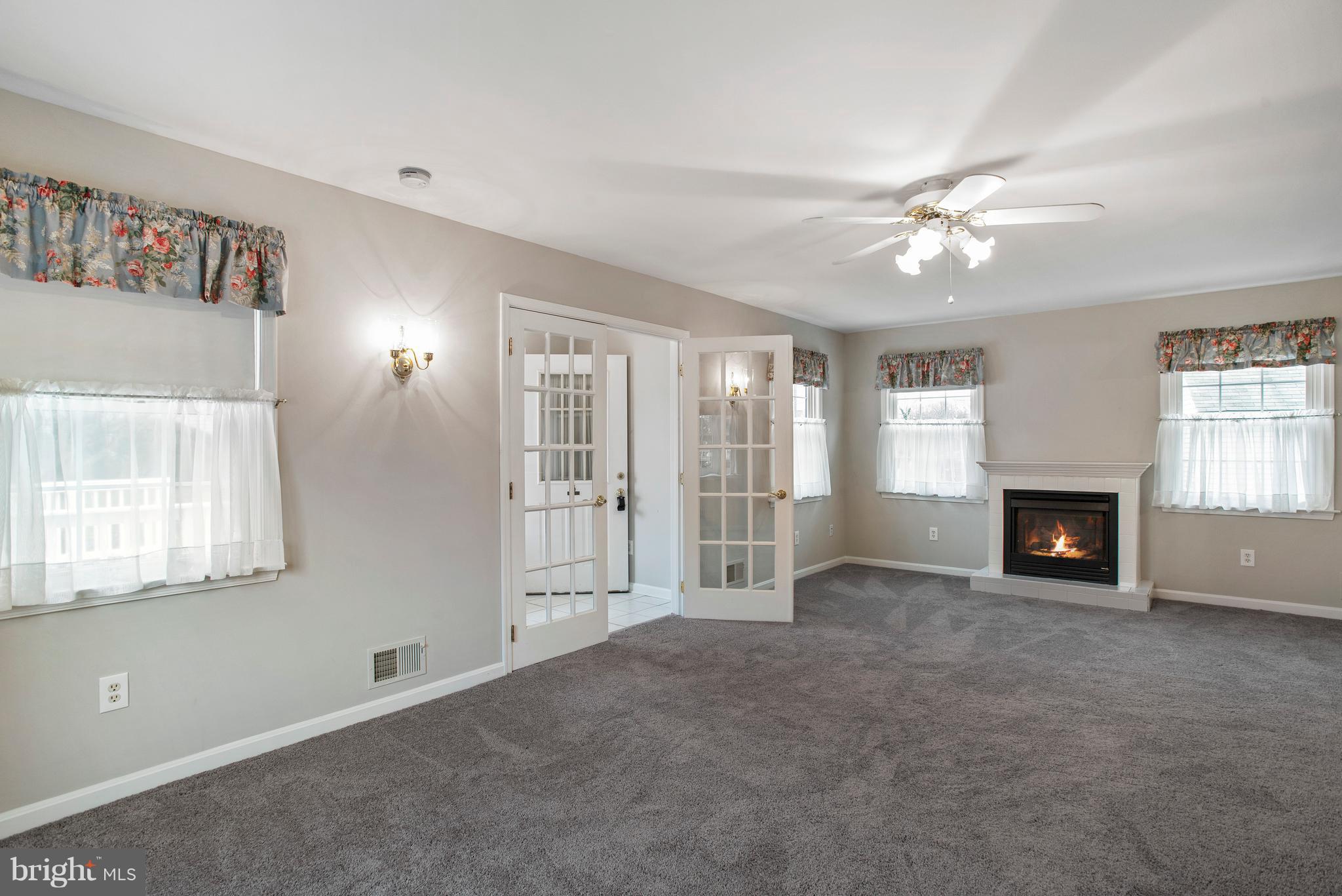 3300 Garnet Road Baltimore, MD 21234 - Photo 6 of 55 a view of an empty room with a fireplace and a window