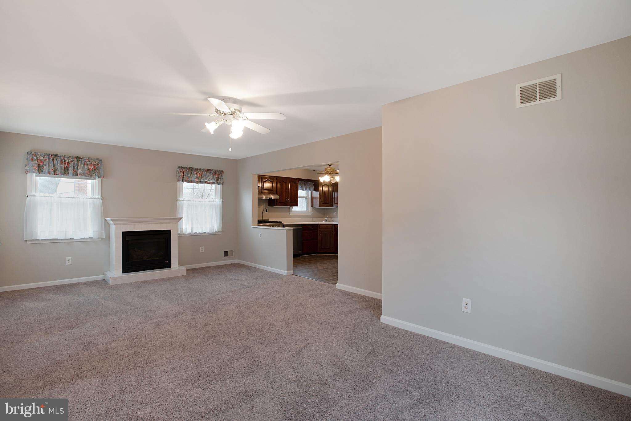 3300 Garnet Road Baltimore, MD 21234 - Photo 7 of 55 an empty room with windows and fireplace