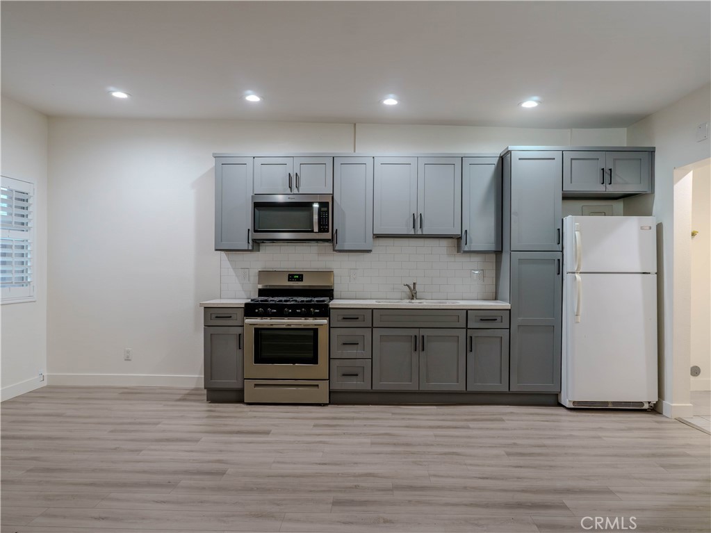 a kitchen with a refrigerator stove and microwave