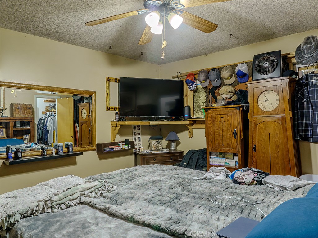 9413 Garfield Street Riverside, CA 92503 - Photo 11 of 33 a bedroom with furniture and a flat screen tv