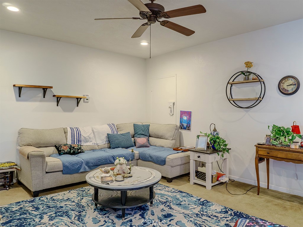 9413 Garfield Street Riverside, CA 92503 - Photo 15 of 33 a living room with furniture a rug and a wall painting