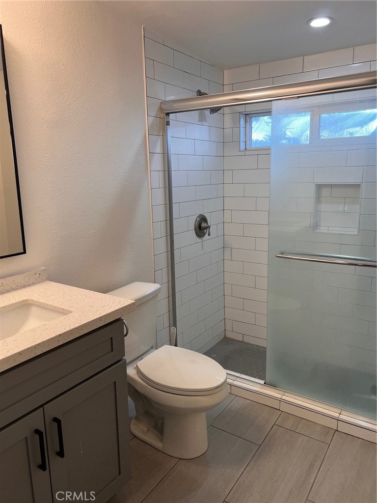 9413 Garfield Street Riverside, CA 92503 - Photo 2 of 5 a bathroom with a sink a toilet and shower