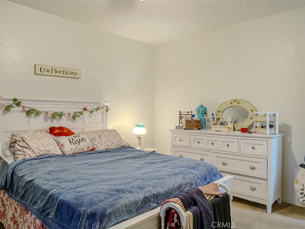 9413 Garfield Street Riverside, CA 92503 - Photo 29 of 33 a bedroom with a bed and a dresser