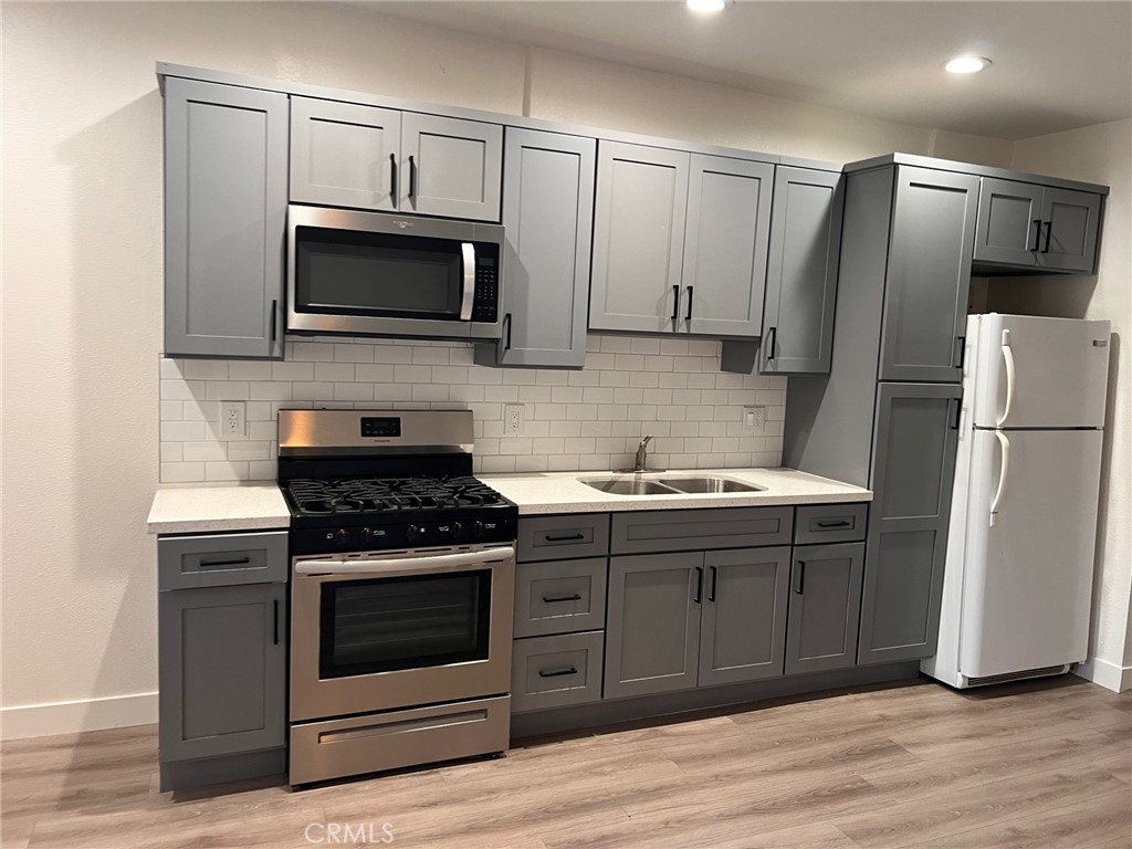 9413 Garfield Street Riverside, CA 92503 - Photo 3 of 5 a kitchen with a sink stove and microwave