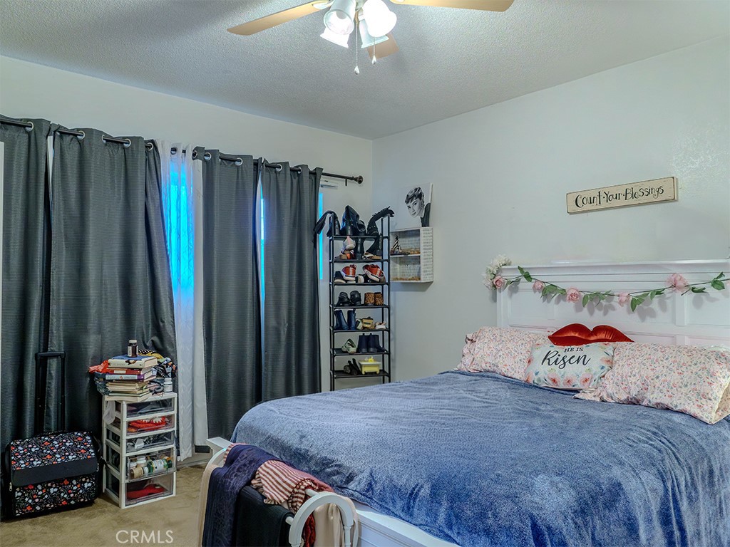 9413 Garfield Street Riverside, CA 92503 - Photo 31 of 33 a bedroom with a bed and a book shelf